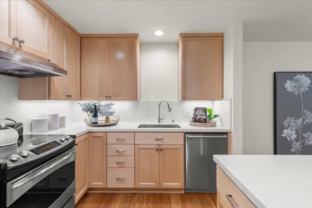 a kitchen with a sink stove and cabinets