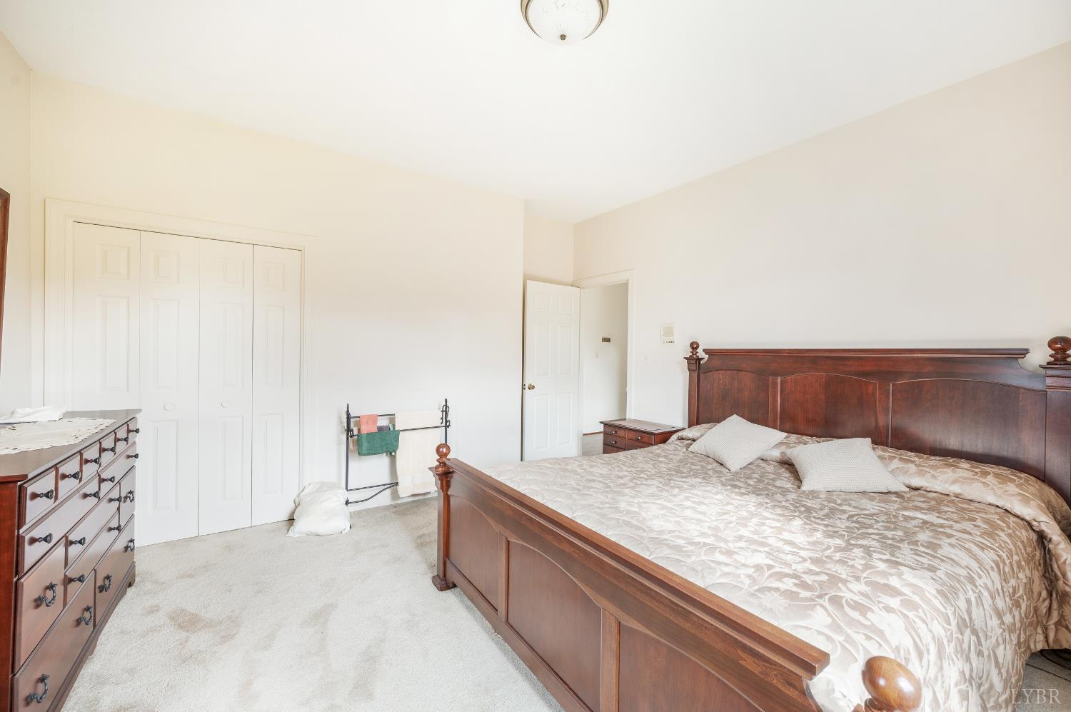 837 Gidsville Road Amherst, VA 24521 - Photo 55 of 82 a bedroom with a large bed and a chandelier