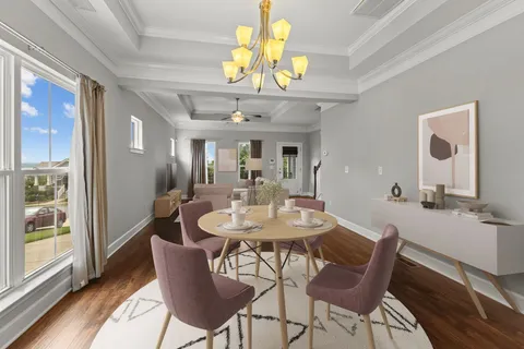 a view of a dining room with furniture and a chandelier