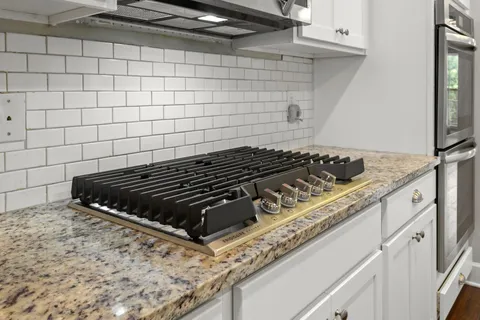 a close view of a stove a microwave and cabinets