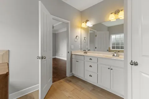 a spacious bathroom with a double vanity sink and mirror