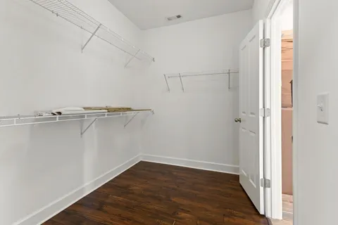 a view of a room with wooden floor