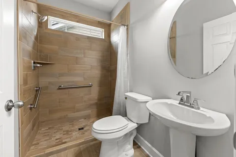 a bathroom with a sink toilet and shower