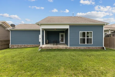 a view of a house with a yard and garage