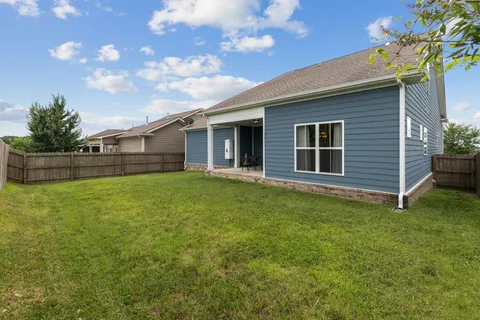 a view of a house with a backyard