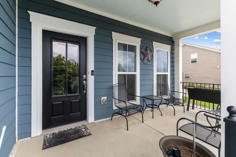 a building outdoor space with patio furniture and potted plants