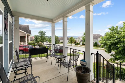 a view of a chairs and table in patio with a fire pit