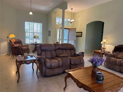 a living room with furniture potted plant and a chandelier
