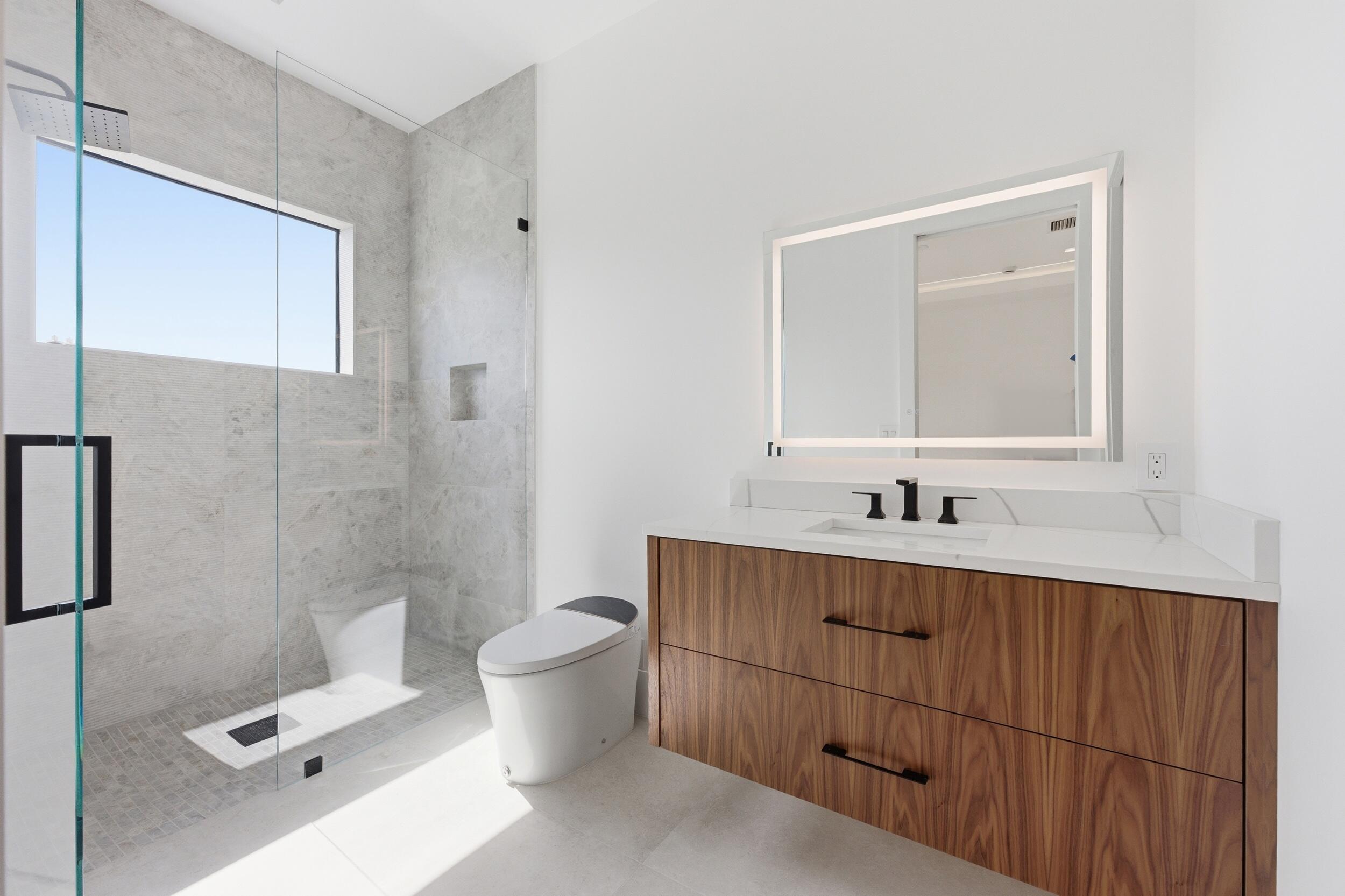 2360 Northeast 49th Street Lighthouse Point, FL 33064 - Photo 50 of 66 a bathroom with a toilet sink and mirror