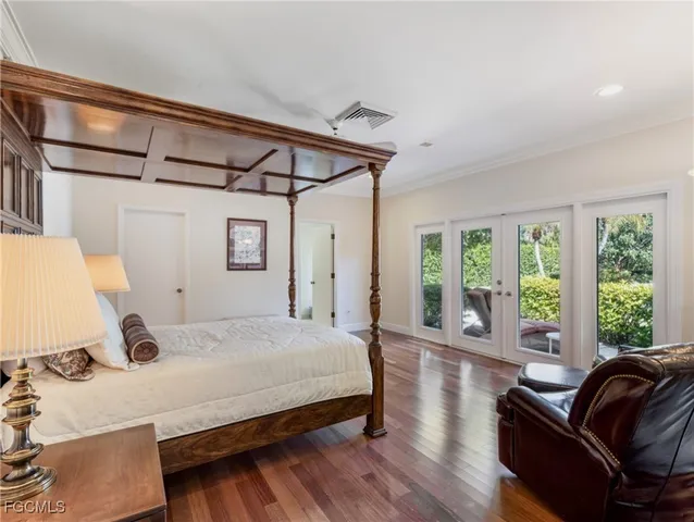 a bedroom with a large bed and a large window