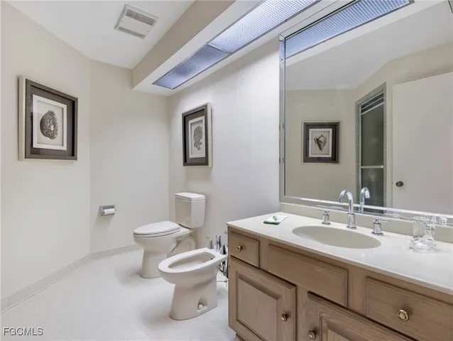 a bedroom with a large bed and a wooden floor