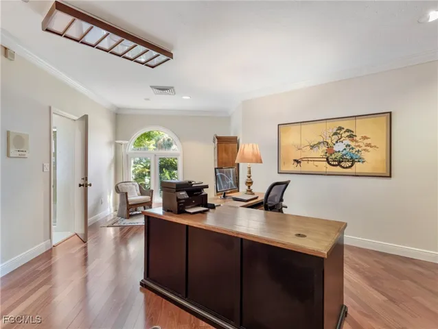 a view of a kitchen with white cabinets and a window