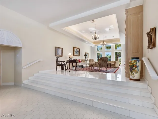 a living room with furniture a rug and a chandelier