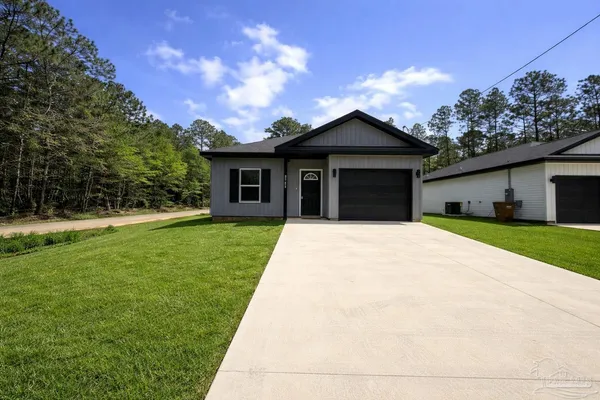 a view of a house with yard and a garden