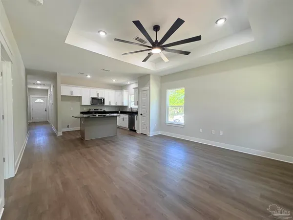 a bathroom with a granite countertop sink toilet a mirror and shower