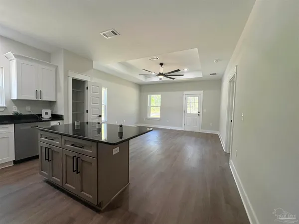 a bathroom with a granite countertop toilet and sink