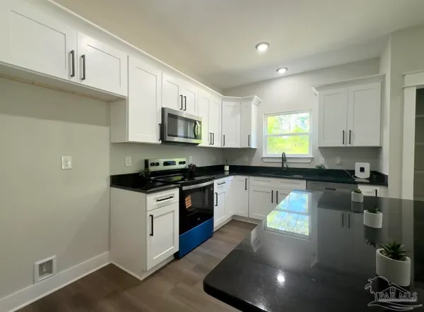 a view of a kitchen with a sink and a stove top oven