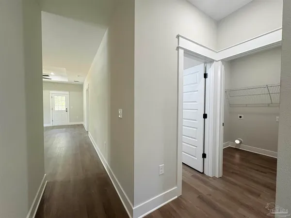 a view of a room with wooden floor and white walls