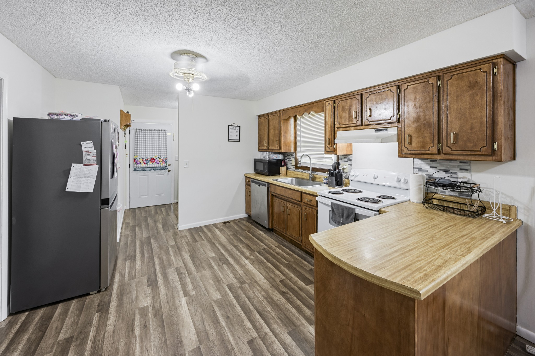 421 Shady Grove Road Flintville, TN 37335 - Photo 22 of 33 a kitchen with a stove a sink dishwasher and a refrigerator