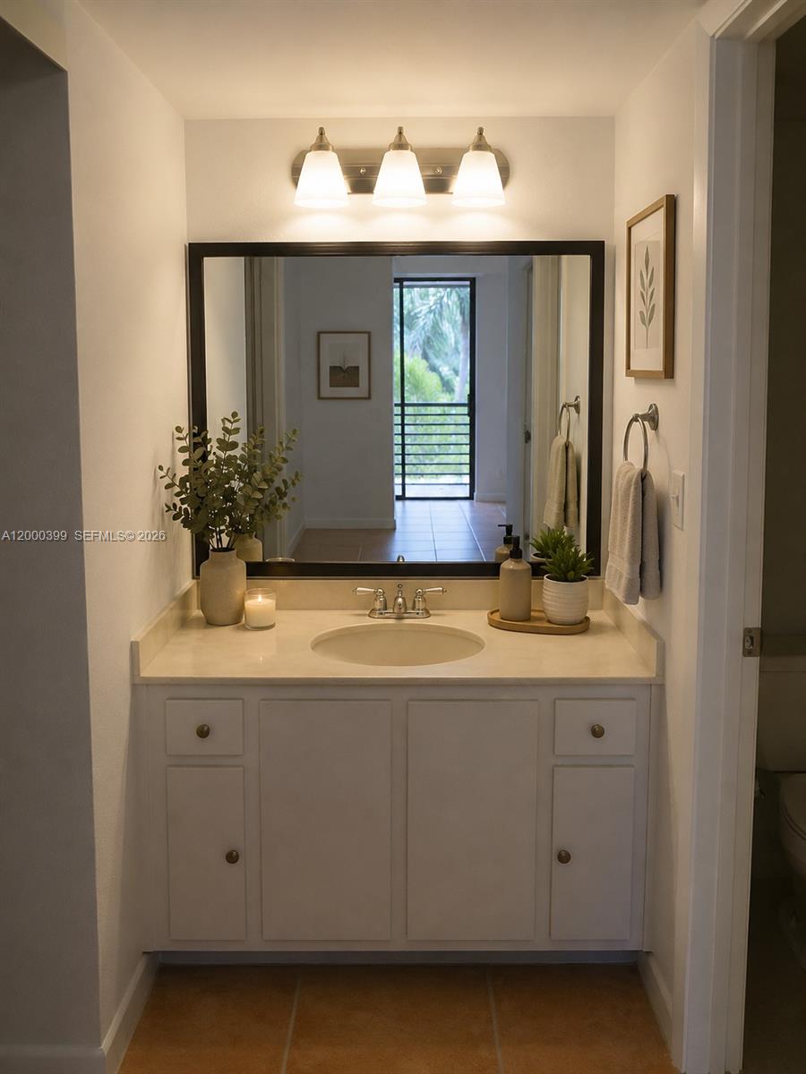 8050 West McNab Road, Unit 206 Tamarac, FL 33321 - Photo 9 of 37 a bathroom with a sink and a mirror