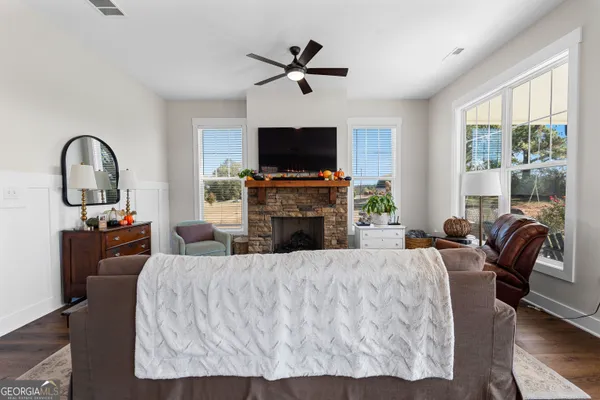 a view of a living room and a window with furniture