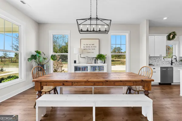 a kitchen with stainless steel appliances a refrigerator sink and white cabinets