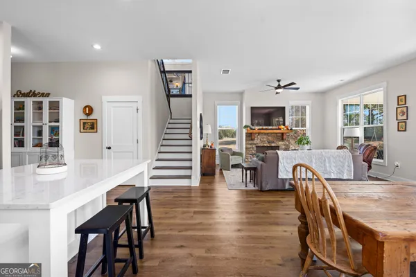 a view of a livingroom with wooden floor and furniture