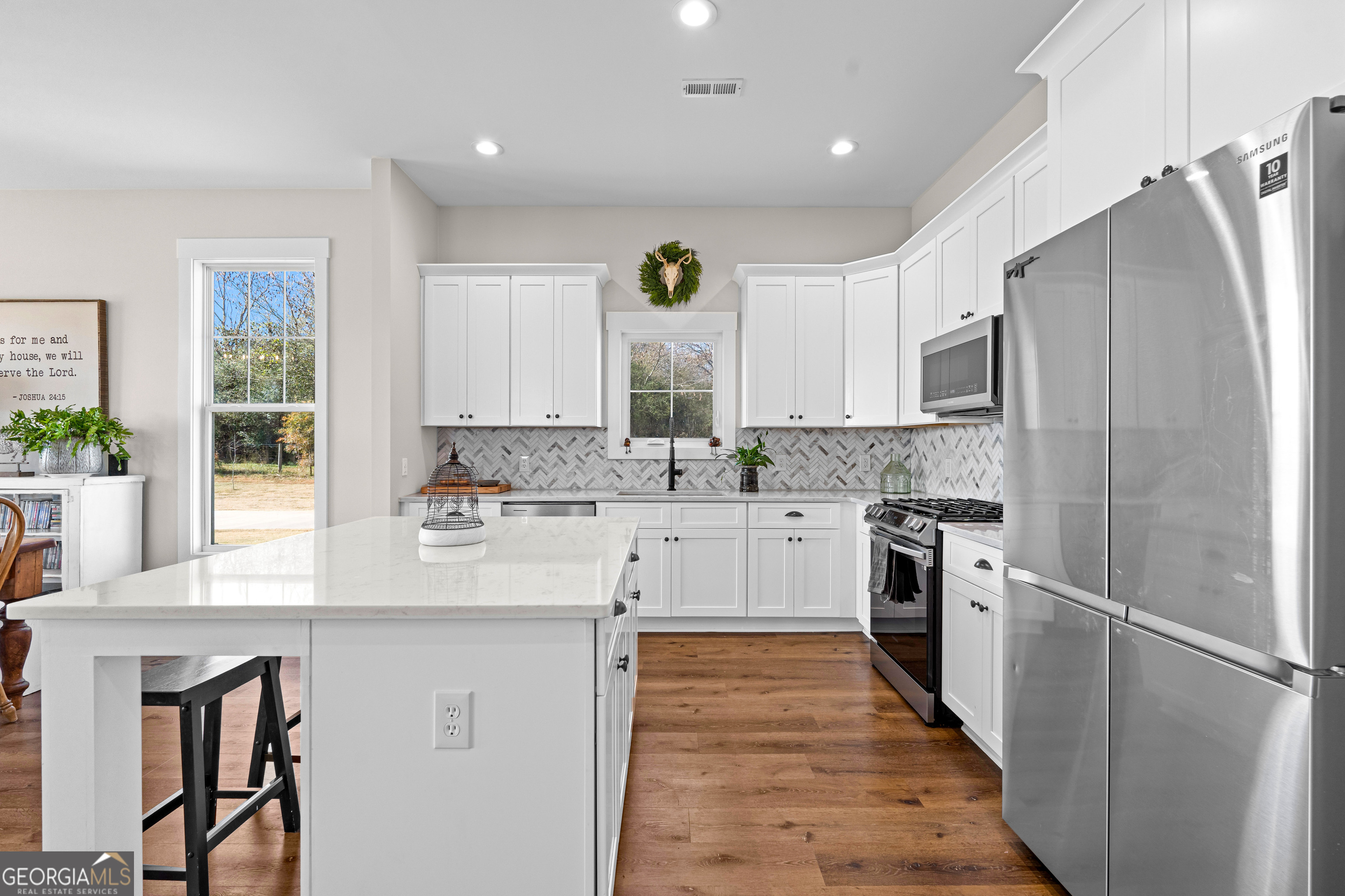 197 Dunn Road Molena, GA 30258 - Photo 20 of 76 a kitchen with stainless steel appliances granite countertop a sink a stove a refrigerator cabinets and a window
