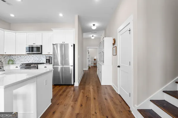 a view of a hallway with furniture and floor to ceiling window