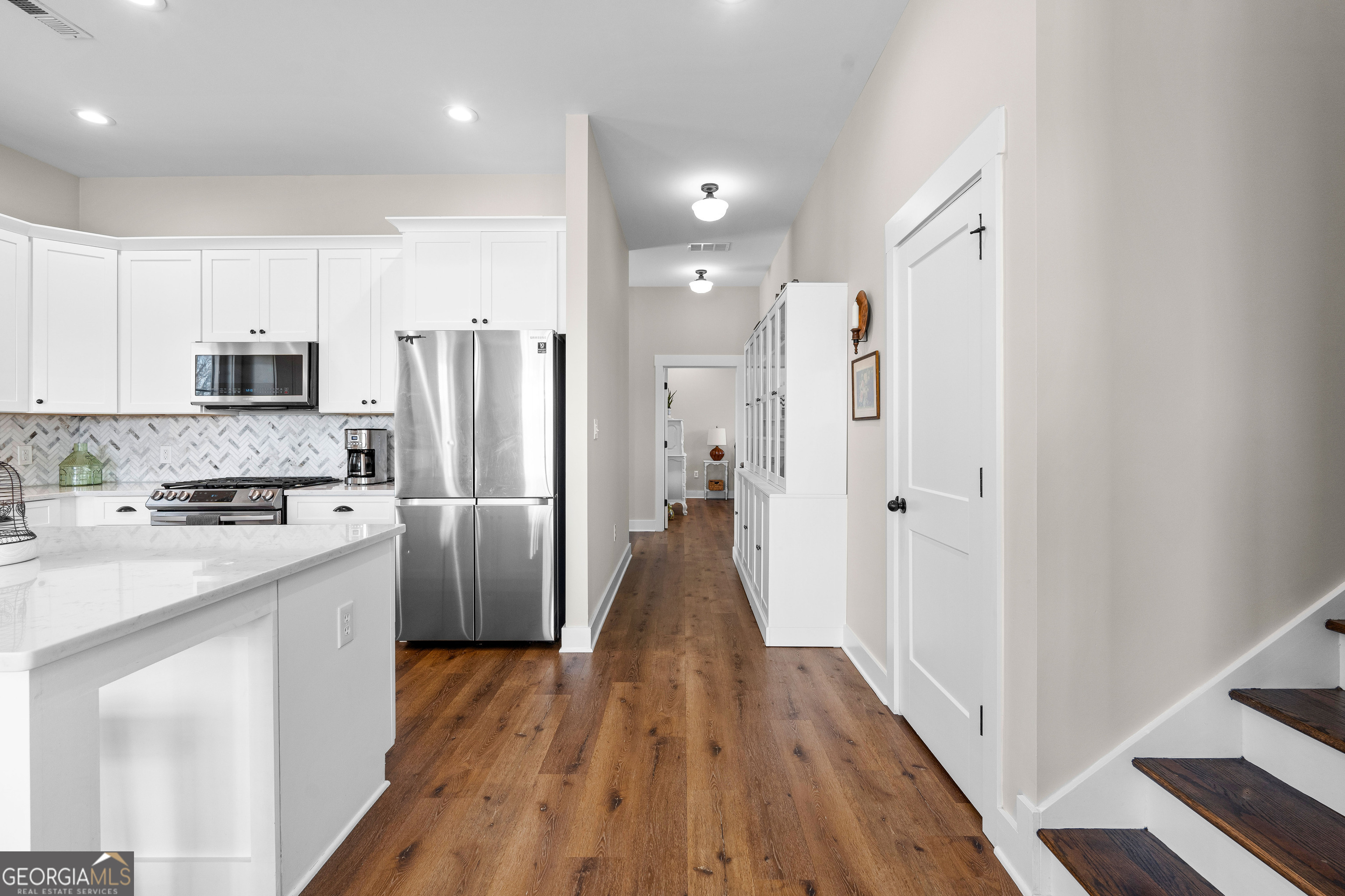 197 Dunn Road Molena, GA 30258 - Photo 22 of 76 a view of a kitchen with a refrigerator a stove top oven a sink and cabinets