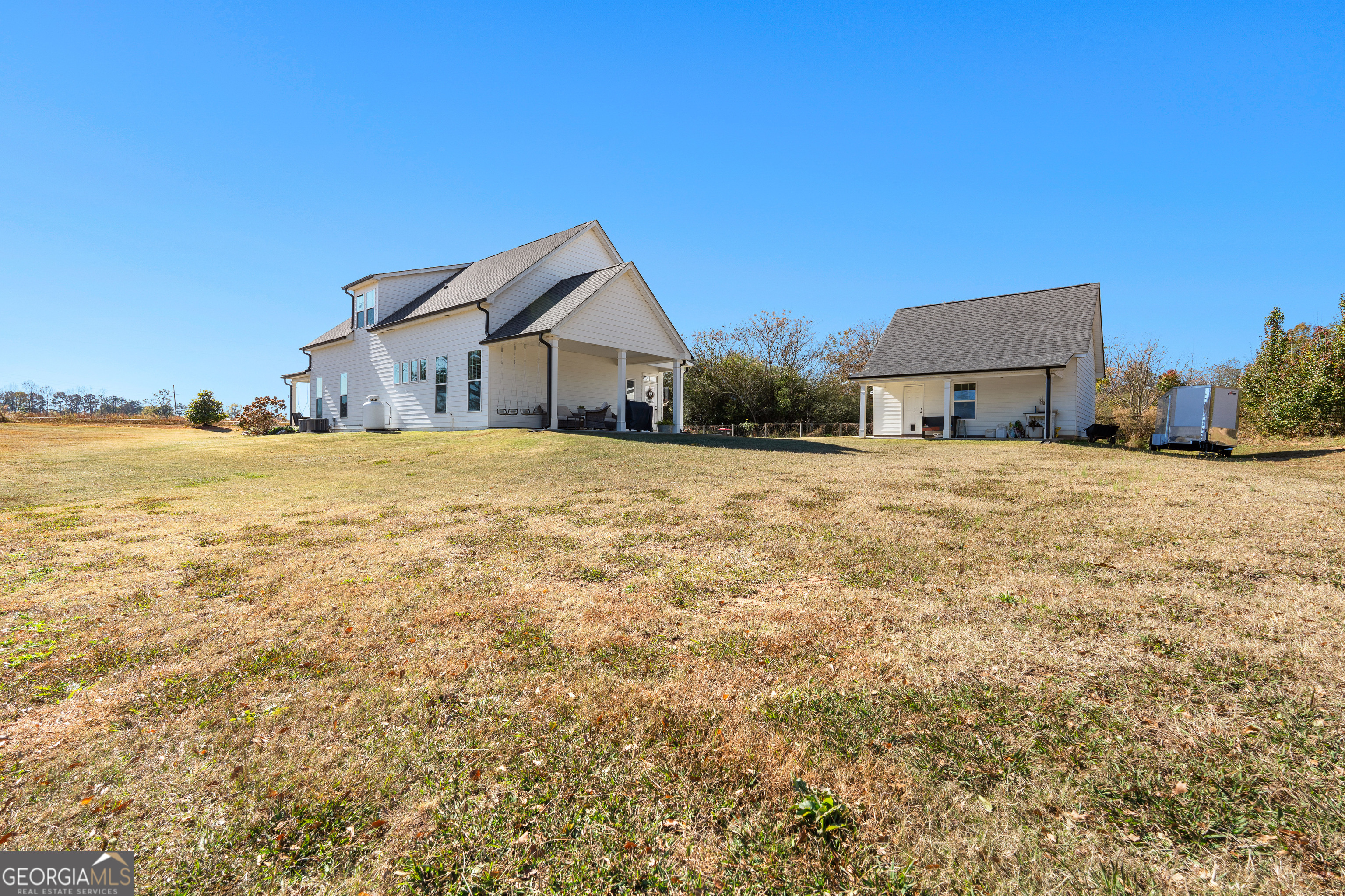 197 Dunn Road Molena, GA 30258 - Photo 60 of 76 a big house with a big yard and large trees