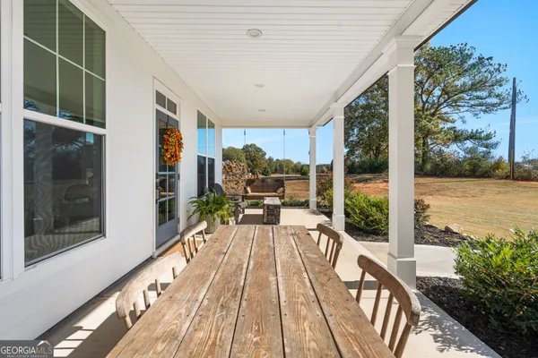 a living room with furniture and kitchen view
