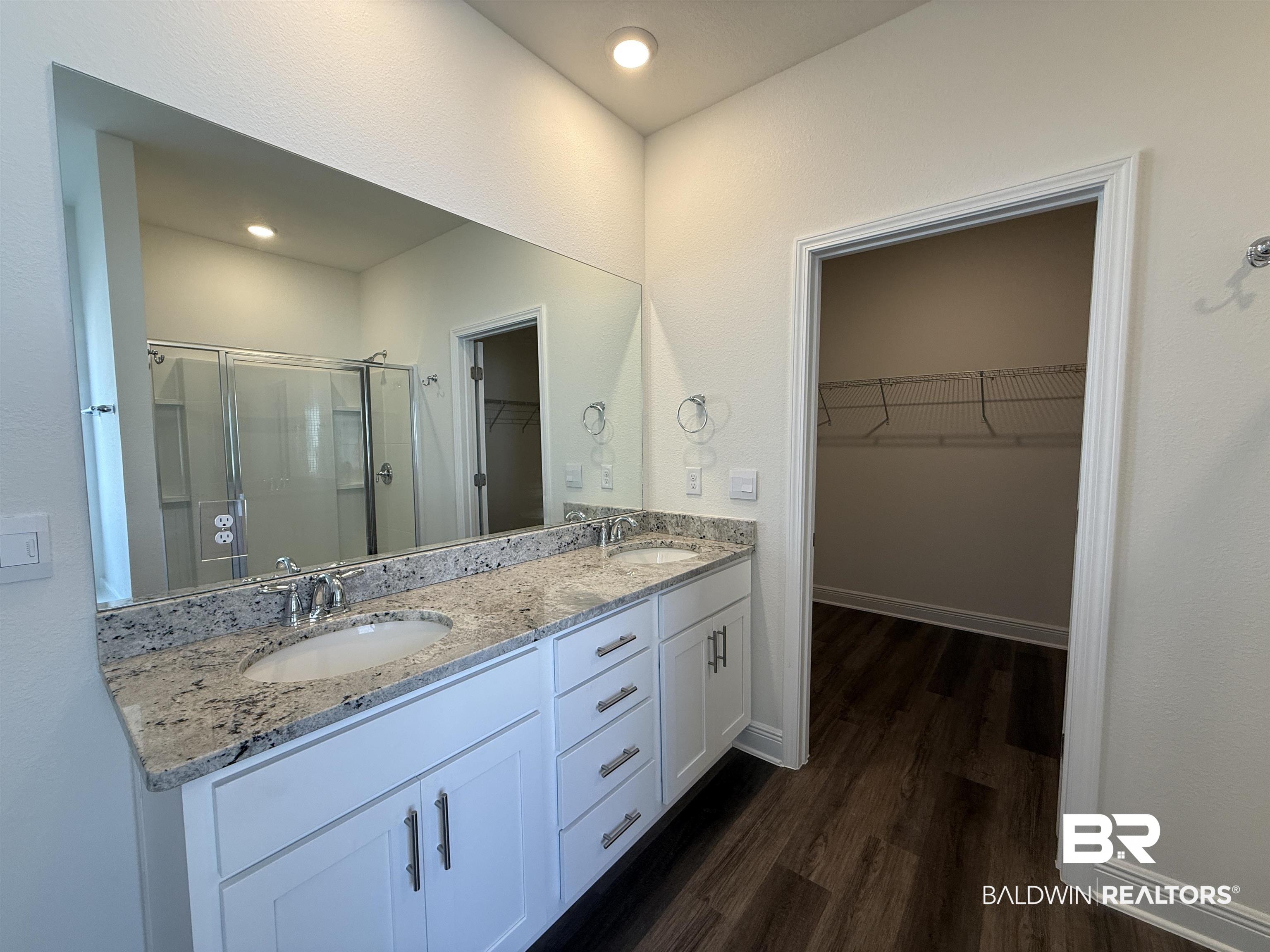 11442 Genuine Risk Circle Daphne, AL 36526 - Photo 11 of 21 Full bathroom with a stall shower, double vanity, a spacious closet, dark wood-style floors, and recessed lighting