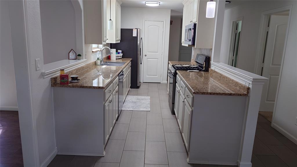 a en suite bathroom with a granite countertop sink and a mirror