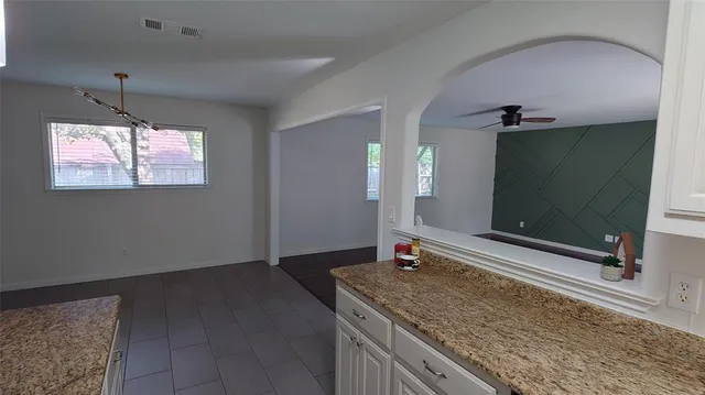 a view of a kitchen with a sink and mirror