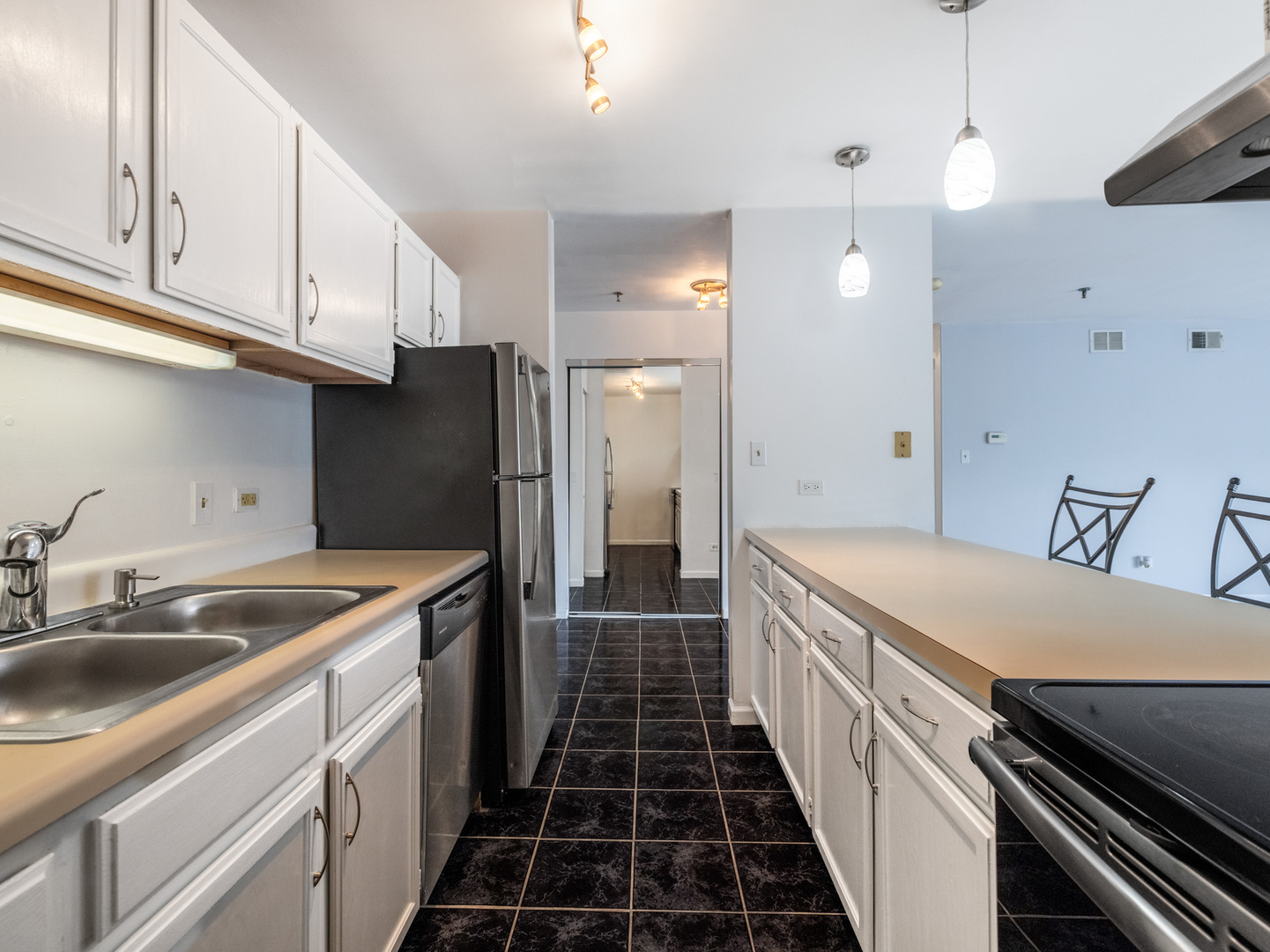 3265 Kirchoff Road, Unit 228 Rolling Meadows, IL 60008 - Photo 7 of 11 a kitchen with a sink and stainless steel appliances