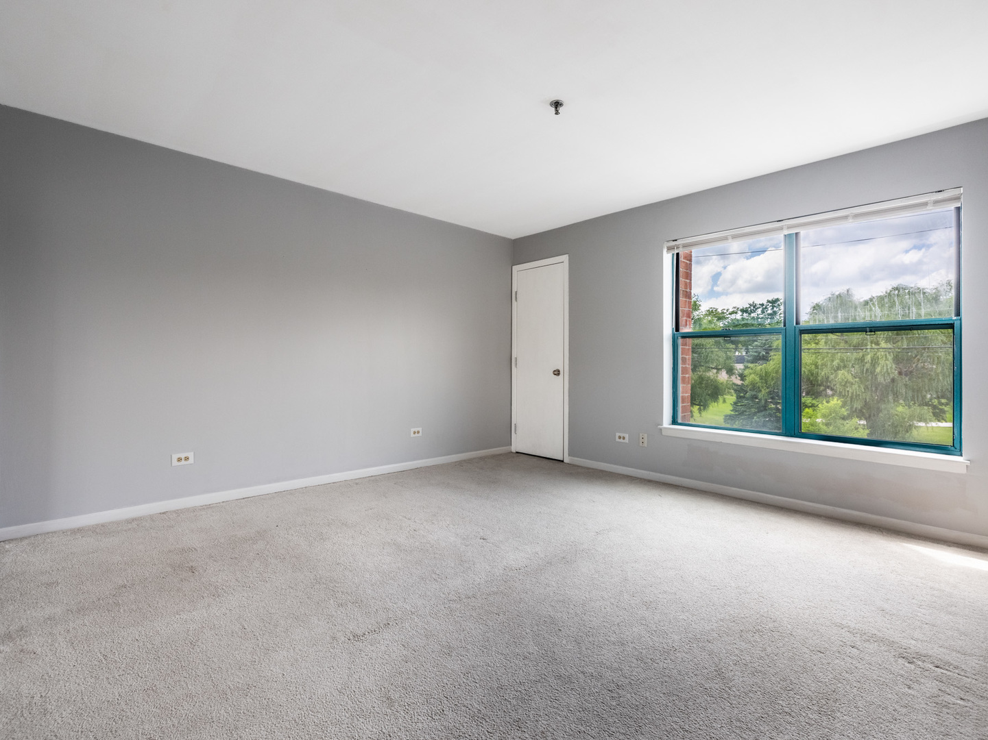 3265 Kirchoff Road, Unit 228 Rolling Meadows, IL 60008 - Photo 8 of 11 a view of an empty room with a window