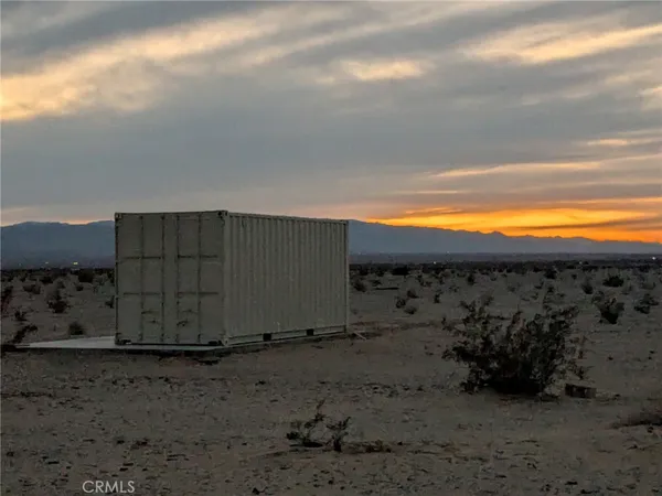 a view of a wooden fence with an outdoor space