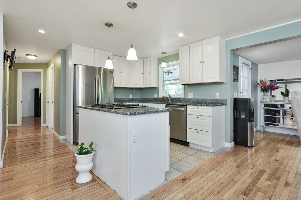 39 Oregon Street Springfield, MA 01118 - Photo 5 of 40 a kitchen with stainless steel appliances kitchen island granite countertop a refrigerator and a stove top oven