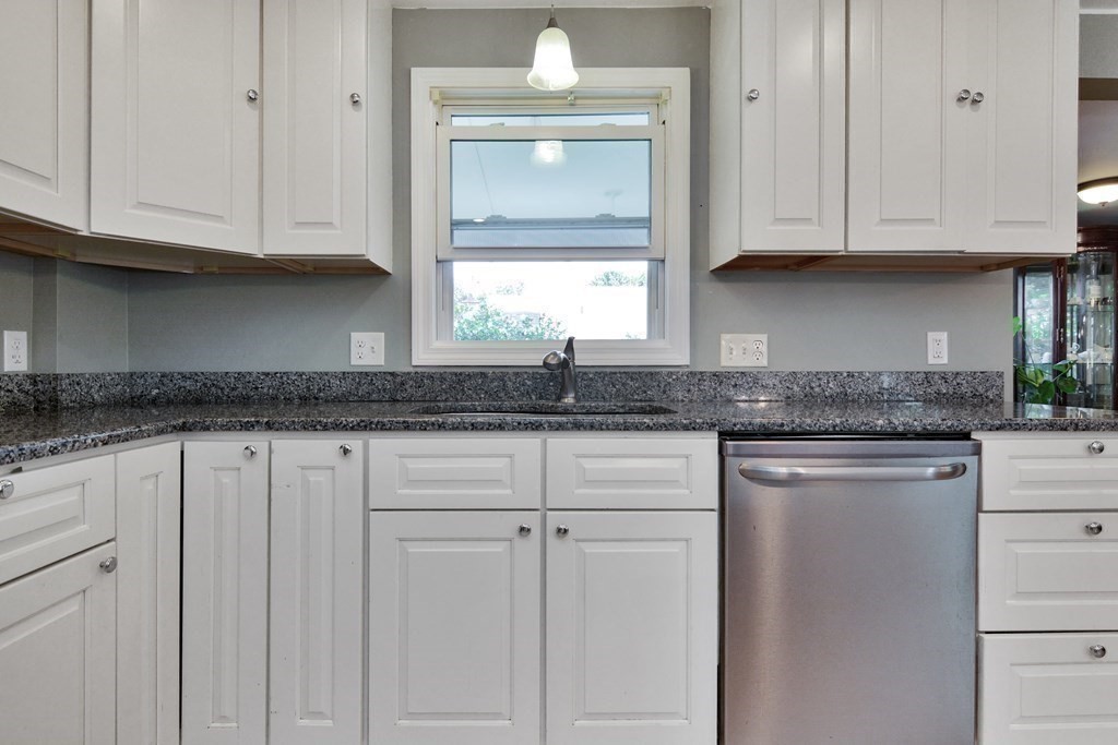 39 Oregon Street Springfield, MA 01118 - Photo 8 of 40 a kitchen with granite countertop white cabinets and a sink