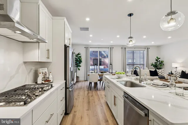 a kitchen with kitchen island granite countertop a table and chairs in it