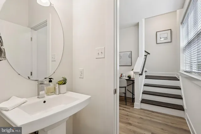 a bathroom with a sink a mirror and a bathtub