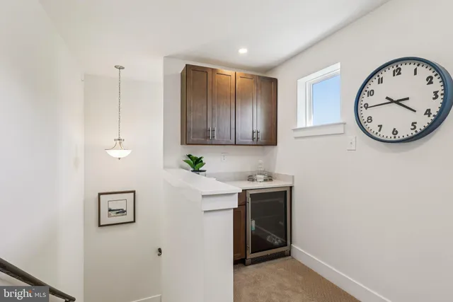a view of a dining room with a table and chairs