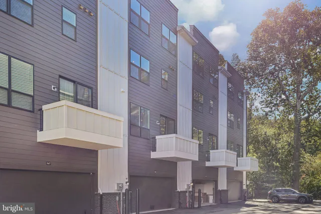 an aerial view of residential houses with outdoor space and lake view