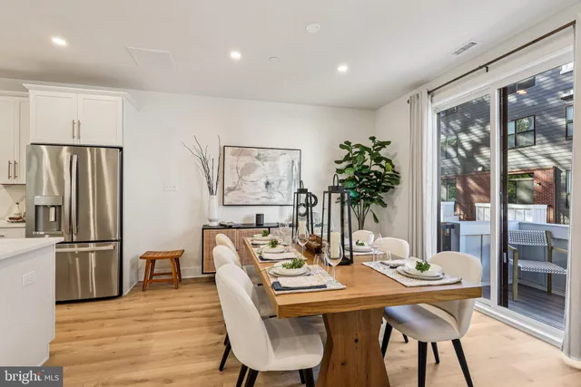 a living room with furniture potted plant and a large window