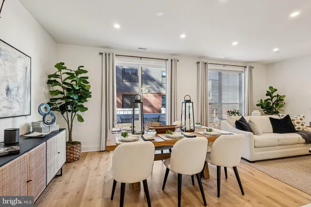 a living room with lots of furniture and a wooden floor
