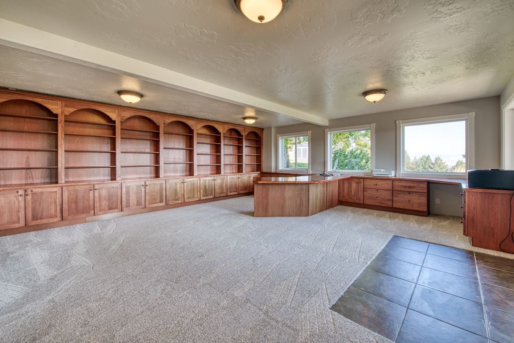 16374 Folsom Road Florence, MT 59833 - Photo 87 of 98 Unfurnished office with a textured ceiling, light carpet, beam ceiling, light tile patterned floors, and built in features