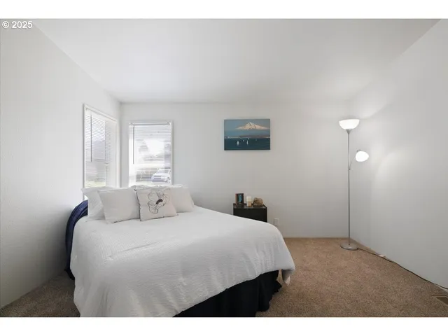 a bathroom with a granite countertop sink a mirror and shower
