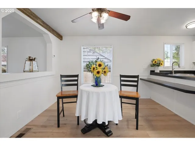 a dining room with furniture wooden floor and chandelier