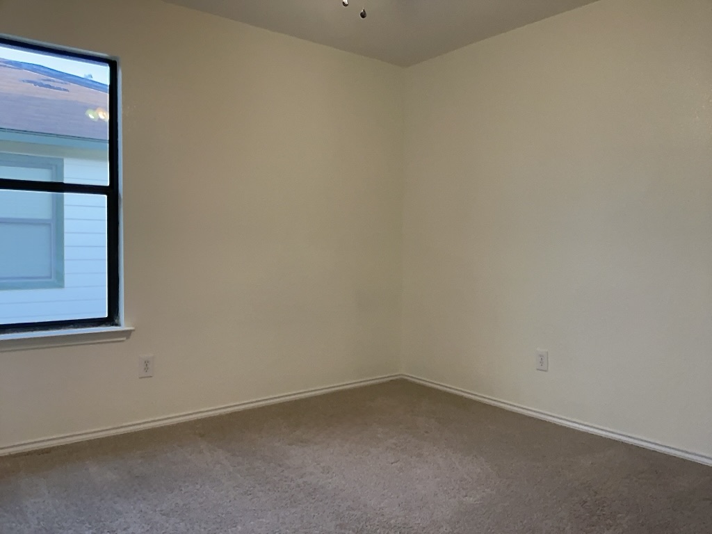 704 Big Sur Trail Taylor, TX 76574 - Photo 14 of 18 Carpeted spare room featuring baseboards